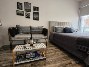 a living room with a bed and a couch and a table at @juanbjustoapartamento in Buenos Aires