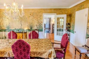a dining room with a table and purple chairs at Gould Swaby Mansion in Seneca Falls