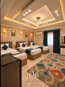 a hotel room with two beds and a rug at Amin Hotel Cairo Downtown in Cairo