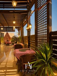 a patio with tables and chairs and a tent at Amin Hotel Cairo Downtown in Cairo