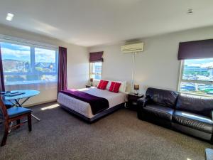 a hotel room with a bed and a couch at Absolute Lake View Motel in Taupo +57 photos