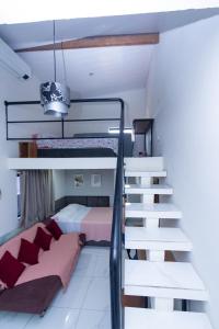 a bedroom with two bunk beds and a staircase at Casa do Henrique 1 in Sorocaba