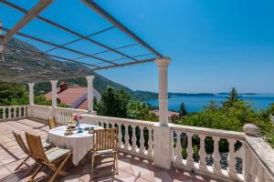 a patio with a table and chairs and a view of the water at Room Blue View in Mlini