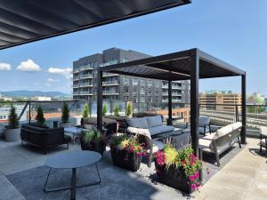 a patio with couches and tables on a building at Suites Cobalt in Quebec City