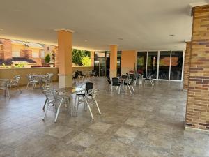 a patio with tables and chairs in a building at Hostal Los Coronales in Madrid