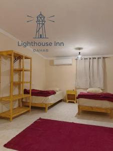 a room with two bunk beds and a sign that reads lighthouse inn at Lighthouse Inn Dahab in Dahab