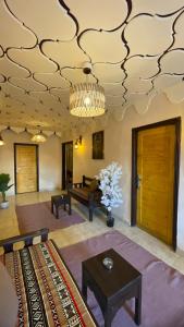 a living room with a ceiling with a chandelier at Lighthouse Inn Dahab in Dahab