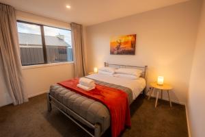 a bedroom with a bed and a window at Totara Haven in Twizel