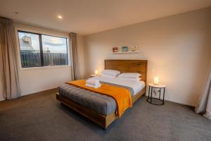 a bedroom with a large bed and a window at Totara Haven in Twizel
