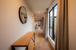 a room with a mirror and a table and a window at Totara Haven in Twizel