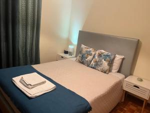 a bedroom with a bed with two towels on it at Alojamento, Chelas Rural AL in Mirandela