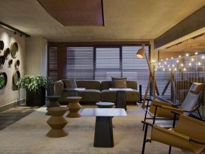 a living room with a couch and chairs at TRIBE Belo Horizonte Savassi in Belo Horizonte