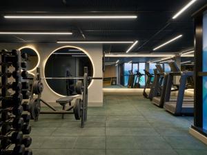 a gym with dumbbells in the middle at TRIBE Belo Horizonte Savassi in Belo Horizonte