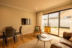 a living room with a couch and a table at Heavenly Hideaway, House B in Twizel