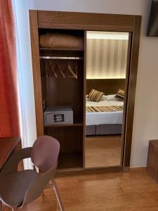 a bedroom with a closet with a bed in it at Hostal Los Coronales in Madrid +53 photos