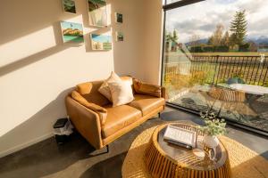 a living room with a couch and a table at Ben Ohau Views The Studio in Twizel