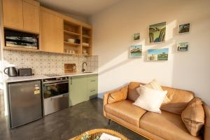 a living room with a couch and a kitchen at Ben Ohau Views The Studio in Twizel