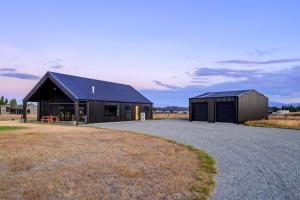 a large black building with a road in front of it at 31 on Boundary in Twizel