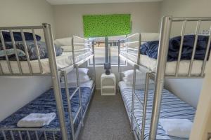 a room with three bunk beds and a lamp at Irishman Drive Escape in Twizel