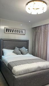 a bedroom with a large bed in a room at NobleStaysTz in Dar es Salaam