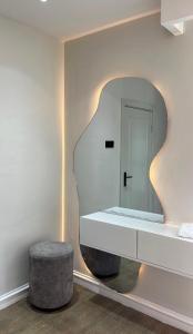 a dressing room with a mirror and a stool at NobleStaysTz in Dar es Salaam +8 photos