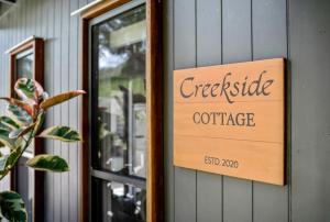a sign on the wall of a coffee shop at Creekside Cottage, pet friendly w pool in Perwillowen