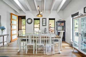 a dining room with a table and chairs at Creekside Cottage, pet friendly w pool in Perwillowen