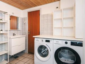 a laundry room with a washer and dryer at 8 person holiday home in Ebeltoft-By Traum in Ebeltoft