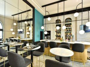 a restaurant with tables and chairs and a bar at ibis Styles Dijon Central in Dijon