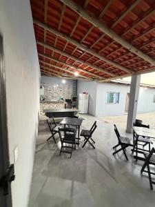 a patio with tables and chairs in a building at Recanto da vale Rs in Três Marias