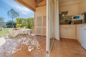 a kitchen with a table and chairs on a patio at La Résidence du Moulin in Tourrettes-sur-Loup