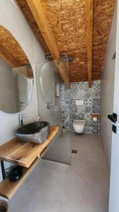 a bathroom with a sink and a toilet at Guesthouse Te Avllia in Këlcyrë