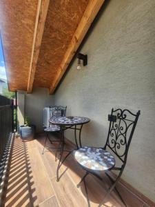 two chairs and a table on a patio at Guesthouse Te Avllia in Këlcyrë