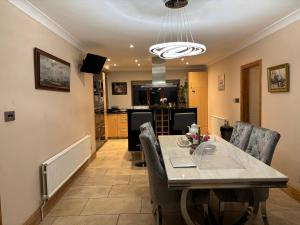 a dining room with a table and some chairs at Batty lodge in Cockerham +6 photos