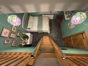 a small room with a bed and a staircase in it at Batty lodge in Cockerham