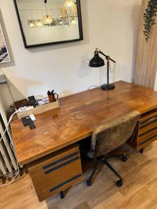 a wooden desk with a lamp on top of it at Old Town Terrace Studio Trier in Trier +10 photos
