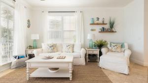 a living room with a white couch and a table at Pristine Islamorada Pool Home with Ocean View and Dockage in Islamorada