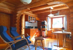 a kitchen with blue chairs and a table in a room at Kamishiro Mountain Lodge in Hakuba +25 photos