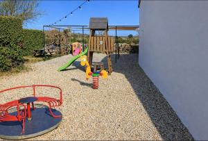 a playground with a play set and a swing at Camping Olé camp in Balazuc