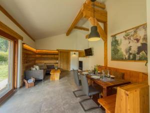 a living room with a table and a couch at Auen 53 in Lake Pressegg