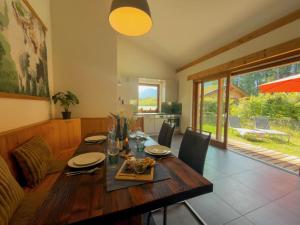 a dining room with a wooden table and chairs at Auen 53 in Lake Pressegg