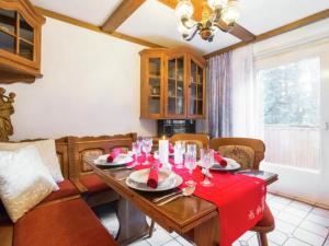 a dining room with a table with a red table cloth at Landhaus Rangersdorf in Rangersdorf +17 photos