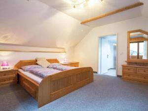 a large bedroom with a wooden bed and a window at Landhaus Rangersdorf in Rangersdorf