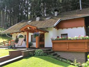 a small house with a porch and a garden at Landhaus Rangersdorf in Rangersdorf