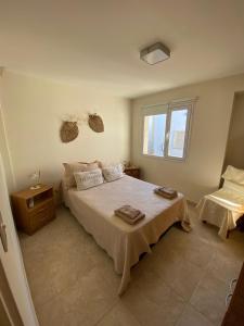 a bedroom with a bed with two towels on it at Alem plaza apart in Comodoro Rivadavia