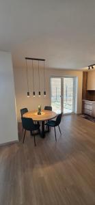 a dining room with a table and chairs at Apartmán Hrdličky Trenčín in Trenčín