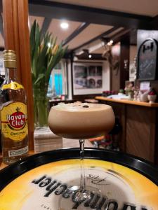 a drink is being poured into a bowl in a pot at Hotel Rauch in Attendorn