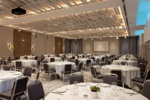 a conference room with tables and chairs and a screen at Sheraton Nice in Nice +176 photos