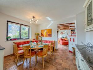 a kitchen and dining room with a table and chairs at Landhaus Herz der Tauern in Mallnitz