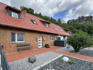 a brick house with a bench in front of it at Mompels in Rübeland